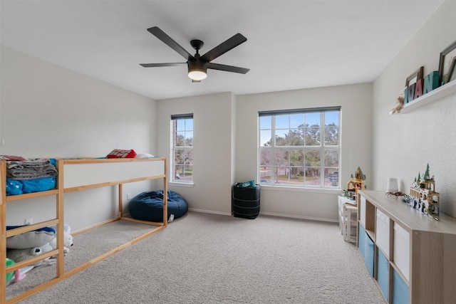 carpeted bedroom featuring baseboards and a ceiling fan