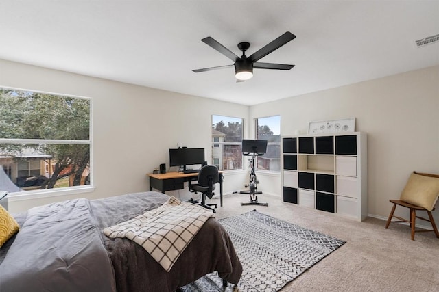 bedroom with carpet floors, visible vents, baseboards, and a ceiling fan