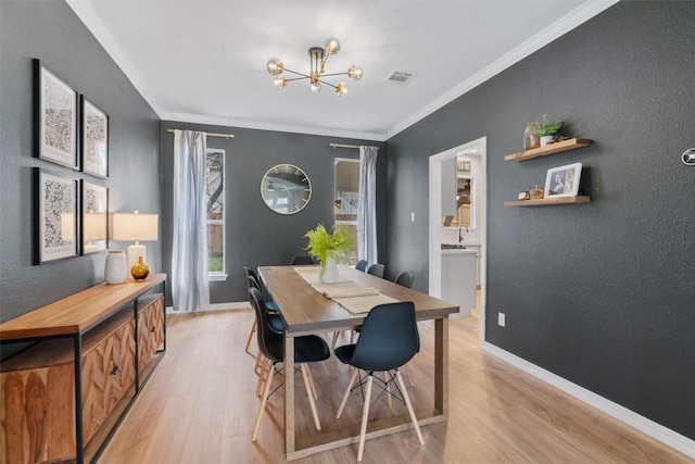 dining space featuring ornamental molding, visible vents, light wood-style flooring, and baseboards