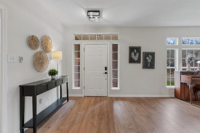 entryway featuring baseboards and wood finished floors