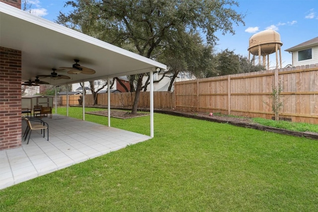 view of yard featuring ceiling fan, a patio area, and fence