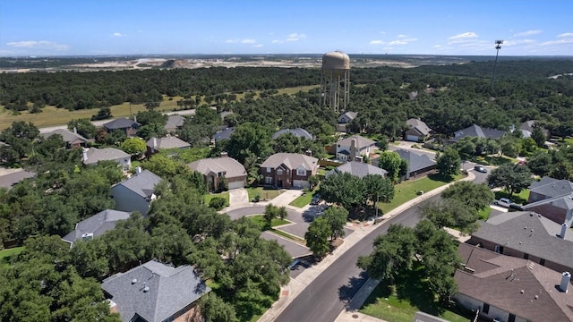 birds eye view of property featuring a residential view and a wooded view