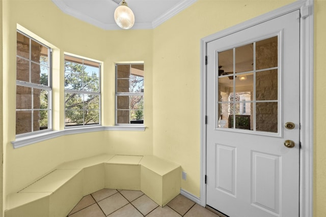 interior space with ornamental molding and light tile patterned floors