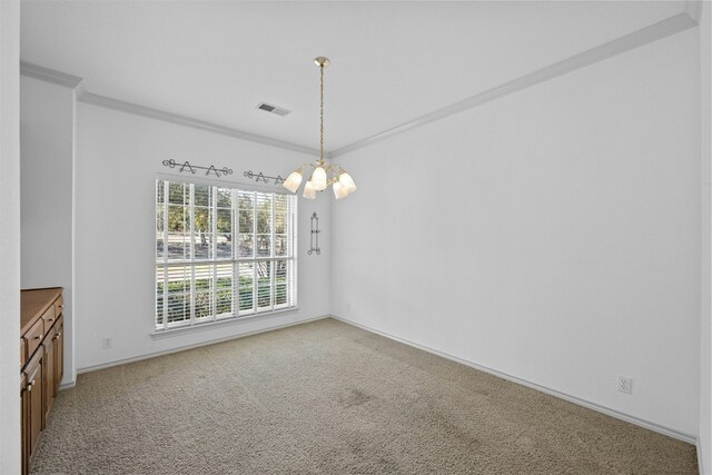 unfurnished dining area featuring ornamental molding, carpet flooring, and a notable chandelier