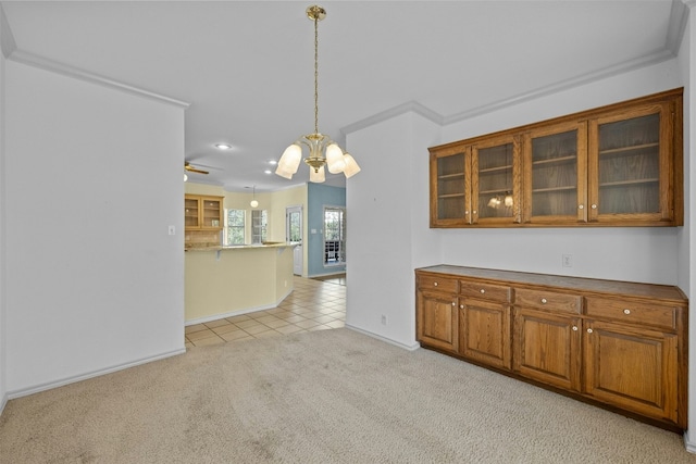 kitchen with hanging light fixtures, light colored carpet, and a chandelier