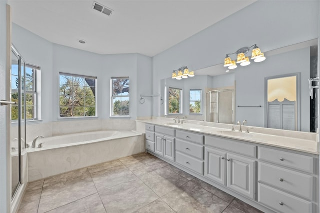 bathroom featuring tile patterned floors, vanity, separate shower and tub, and a wealth of natural light