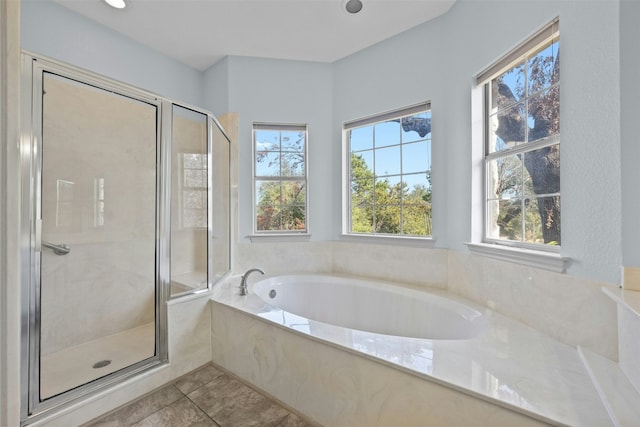 bathroom featuring tile patterned floors and independent shower and bath