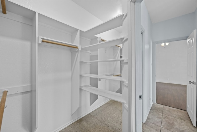 walk in closet featuring light tile patterned flooring