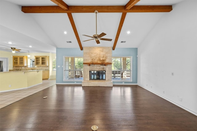 unfurnished living room with hardwood / wood-style flooring, a fireplace, and a healthy amount of sunlight