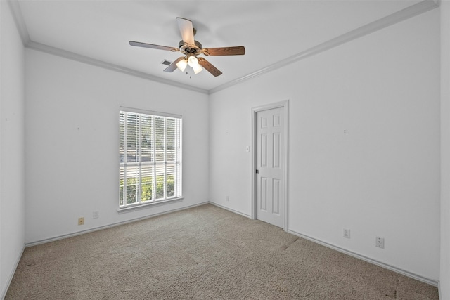 carpeted spare room featuring ornamental molding and ceiling fan