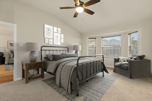 carpeted bedroom with ceiling fan and vaulted ceiling