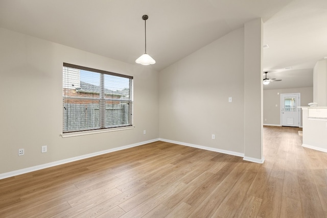 spare room with light hardwood / wood-style flooring, ceiling fan, and vaulted ceiling