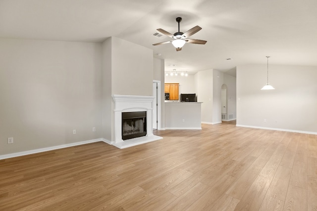 unfurnished living room with ceiling fan, light hardwood / wood-style flooring, and vaulted ceiling