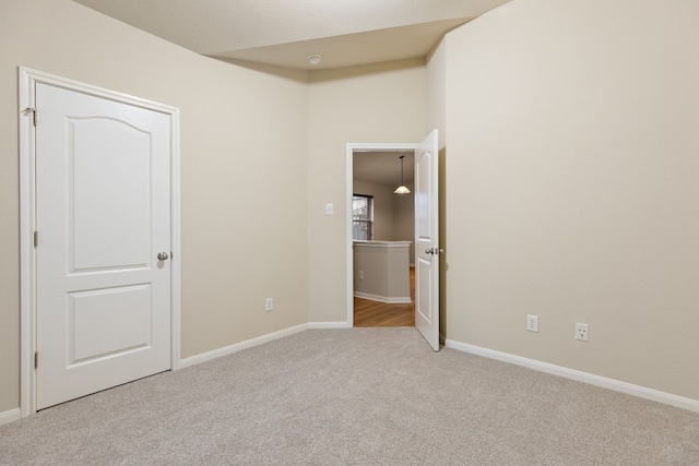 unfurnished bedroom featuring light carpet