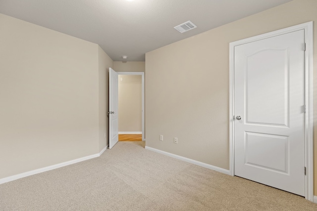 unfurnished bedroom with light carpet