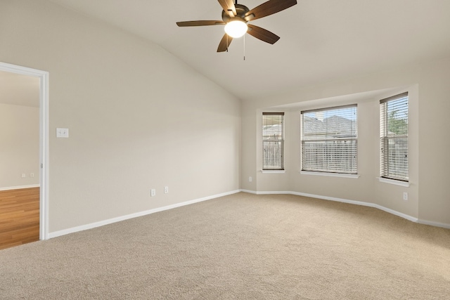 carpeted spare room with lofted ceiling and ceiling fan