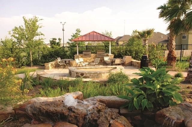 exterior space featuring an outdoor fire pit, a patio area, and a gazebo