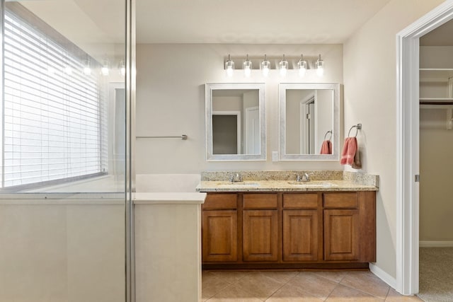 4323 Fairway Path, Round Rock, TX 78665 - full bathroom featuring double vanity, tile patterned flooring, and a spacious closet