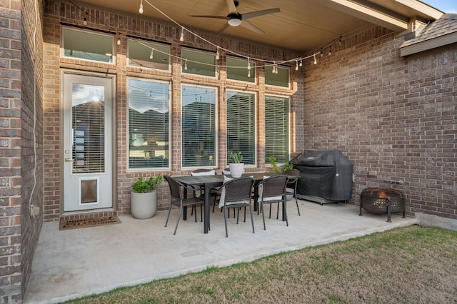 view of patio featuring area for grilling, ceiling fan, and an outdoor fire pit