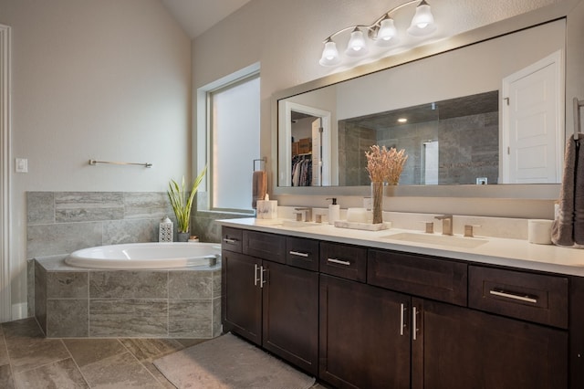 bathroom featuring vanity and shower with separate bathtub