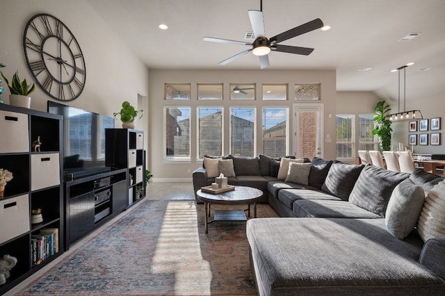 living room featuring ceiling fan and lofted ceiling