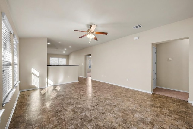 15210 Walcott Dr, Austin, TX 78725 - unfurnished living room featuring a ceiling fan, stone finish floors, and recessed lighting