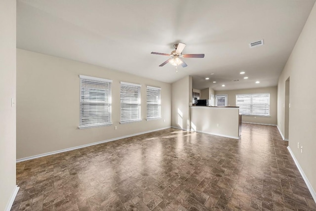 15210 Walcott Dr, Austin, TX 78725 - unfurnished living room featuring ceiling fan and recessed lighting