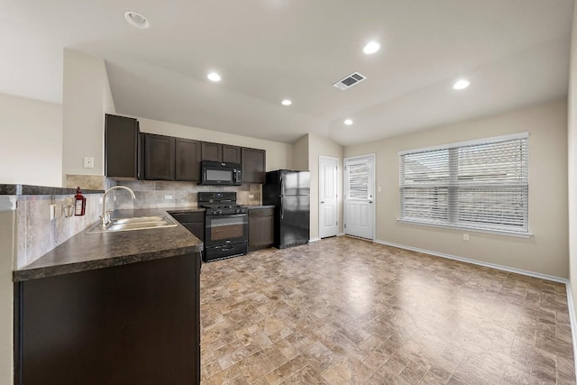 15210 Walcott Dr, Austin, TX 78725 - kitchen featuring black appliances, dark countertops, backsplash, recessed lighting, and lofted ceiling