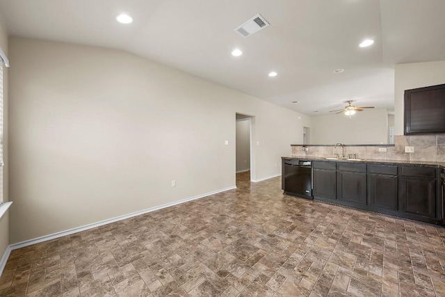 15210 Walcott Dr, Austin, TX 78725 - kitchen with dishwasher, ceiling fan, tasteful backsplash, stone finish floors, and lofted ceiling