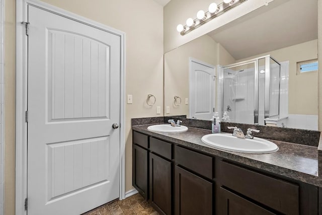 15210 Walcott Dr, Austin, TX 78725 - bathroom featuring double vanity, a shower stall, and vaulted ceiling