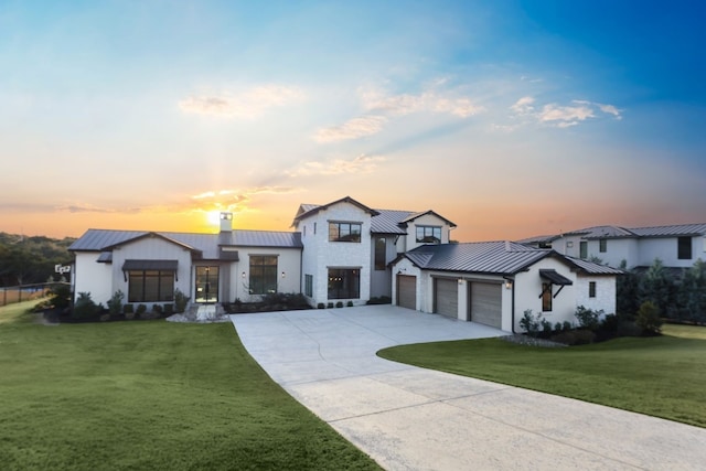 view of front facade featuring a garage and a lawn