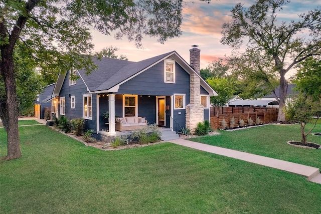 craftsman inspired home with a lawn and covered porch