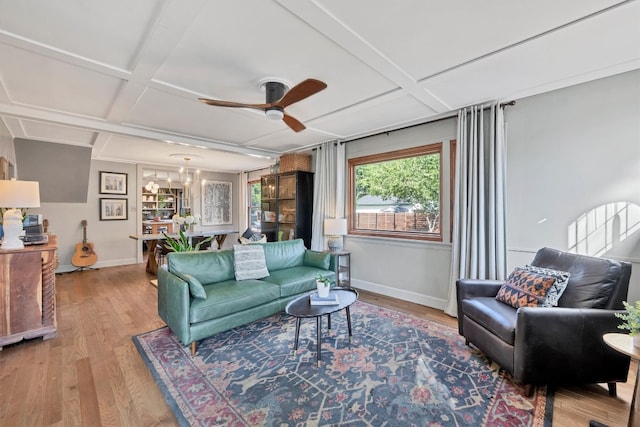 living room with ceiling fan, coffered ceiling, hardwood / wood-style floors, and beam ceiling