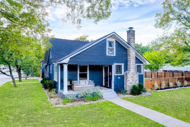 bungalow-style home with a front yard