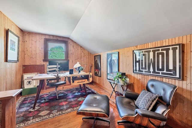 office area with lofted ceiling, hardwood / wood-style floors, and wood walls