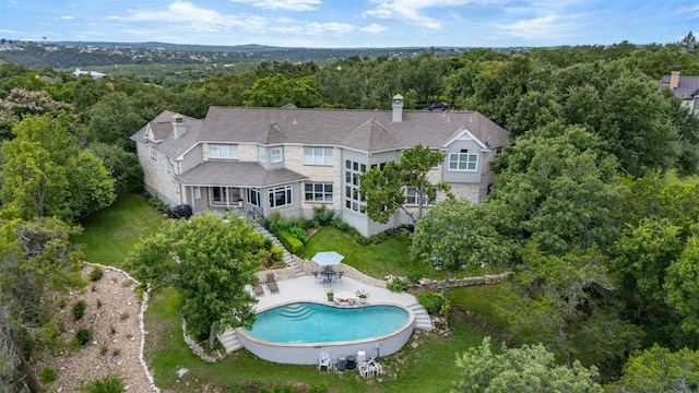 drone / aerial view with a view of trees