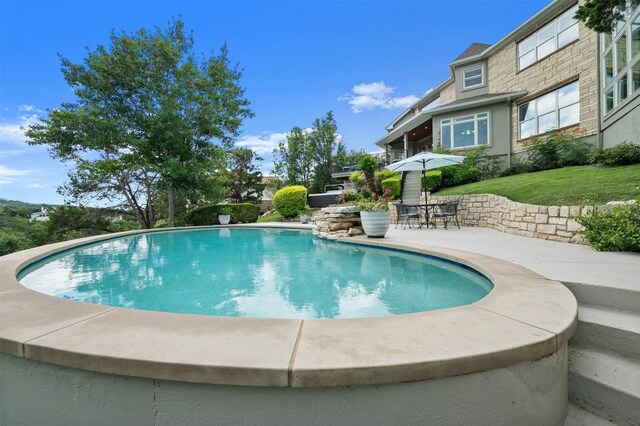 view of swimming pool with a patio