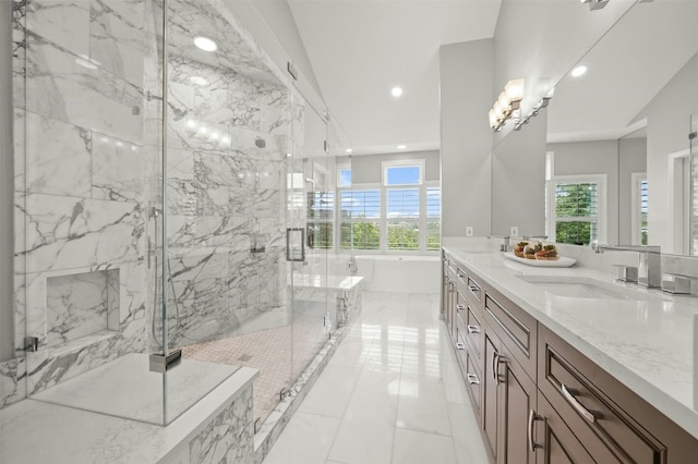 full bathroom with a marble finish shower, double vanity, recessed lighting, a freestanding bath, and a sink