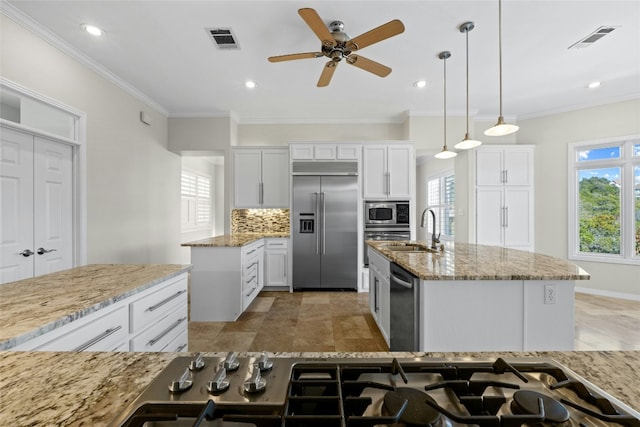 kitchen featuring tasteful backsplash, visible vents, a sink, and built in appliances