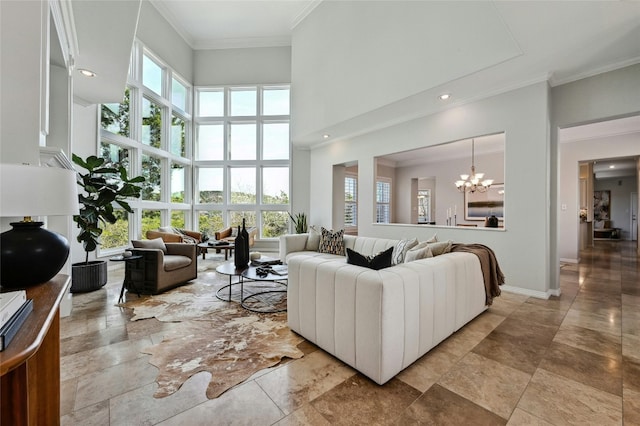 living room with a healthy amount of sunlight, a high ceiling, a chandelier, and crown molding