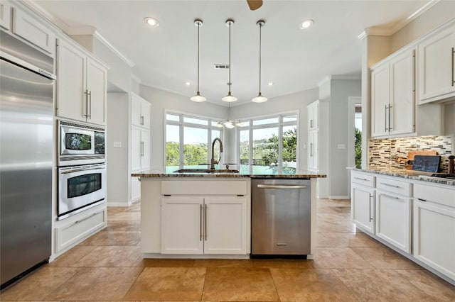 kitchen featuring built in appliances, a sink, backsplash, light stone countertops, and crown molding