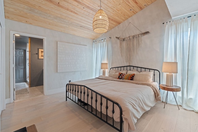 bedroom featuring lofted ceiling, wooden ceiling, and light hardwood / wood-style floors