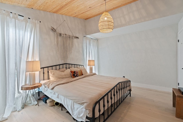 bedroom with wood ceiling and hardwood / wood-style floors