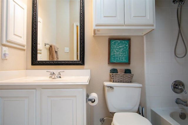 full bathroom with vanity, tiled shower / bath, and toilet