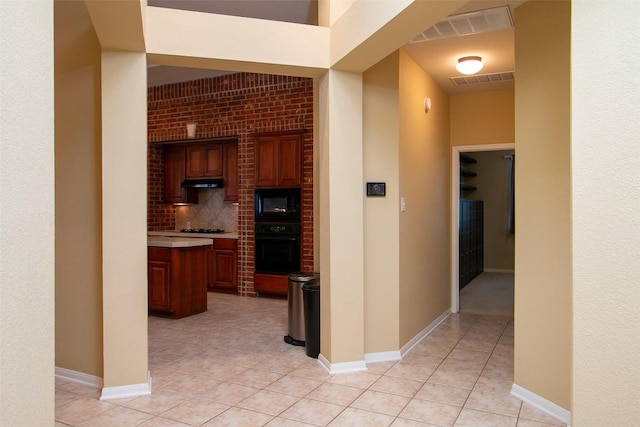 hall with light tile patterned flooring