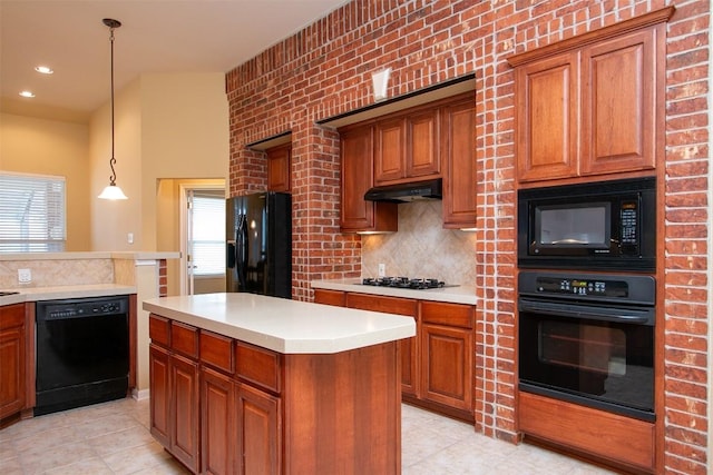 kitchen featuring tasteful backsplash, hanging light fixtures, light tile patterned floors, a kitchen island, and black appliances