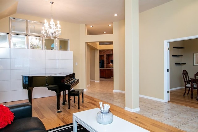 living room featuring a notable chandelier and light hardwood / wood-style floors