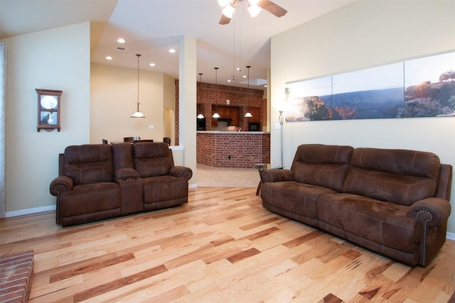 living room with ceiling fan and light hardwood / wood-style floors