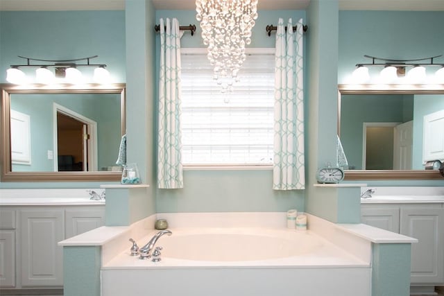 bathroom featuring vanity, a notable chandelier, and a bathtub