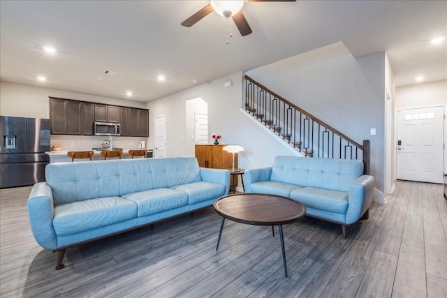 122 Fairmeadow Downs Dr, Hutto, TX 78634 - living room featuring a ceiling fan, light wood-style floors, stairs, and recessed lighting